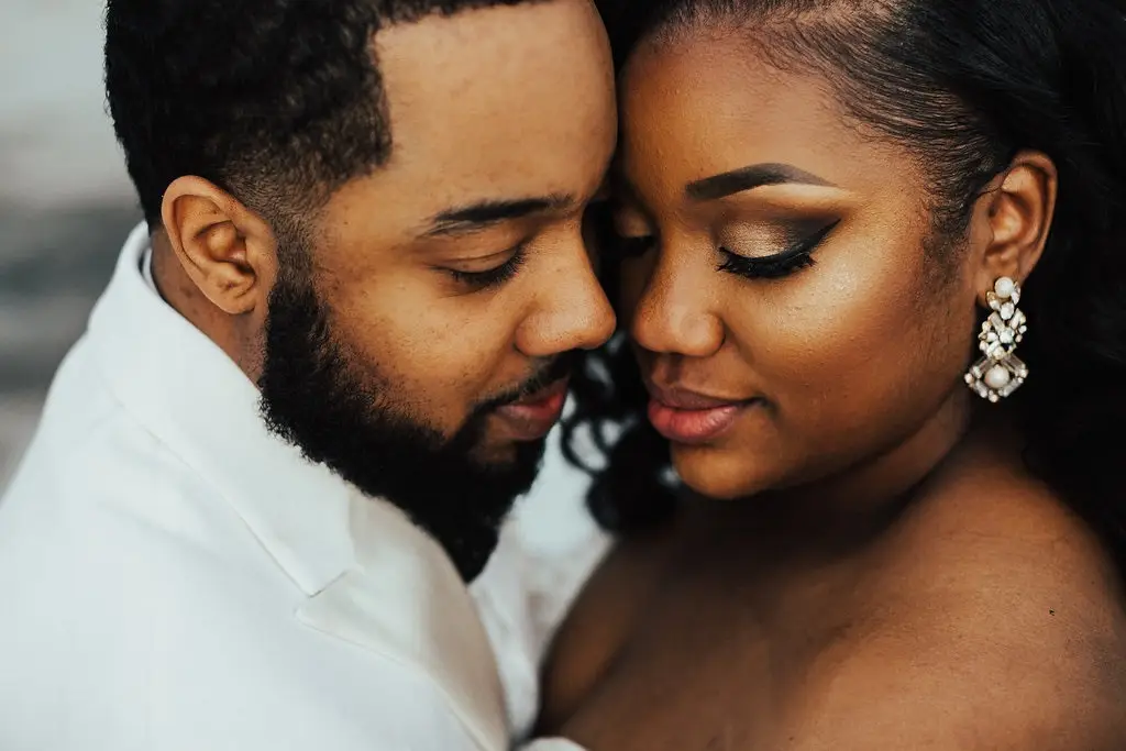 Bride and groom sharing a tender moment, focusing on each other during the photo session.