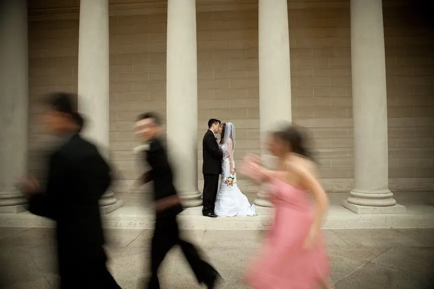 Wedding couple enjoying a kiss with motion blur capturing the energy and excitement of the moment.